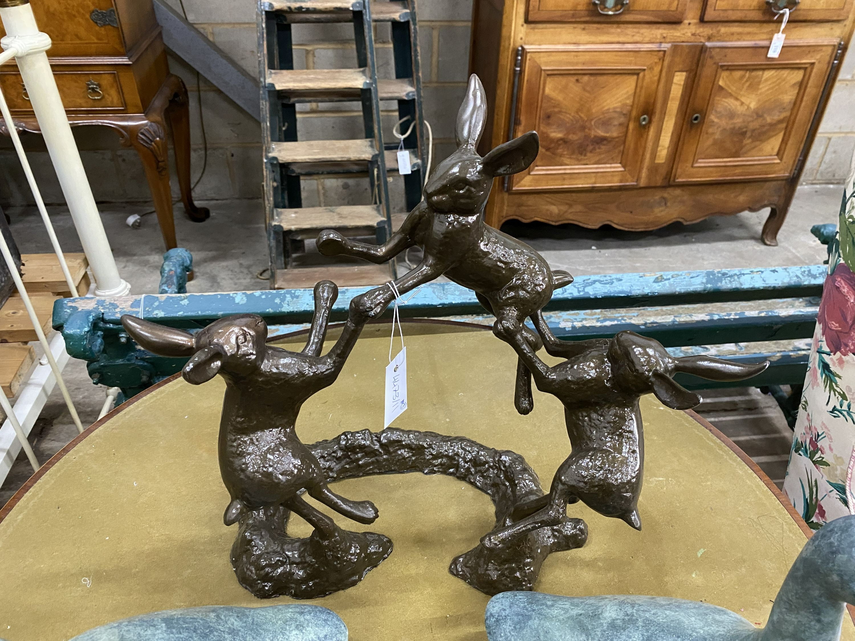 A simulated bronze hare garden ornament, height 46cm, together with two faux bronze models of ducks